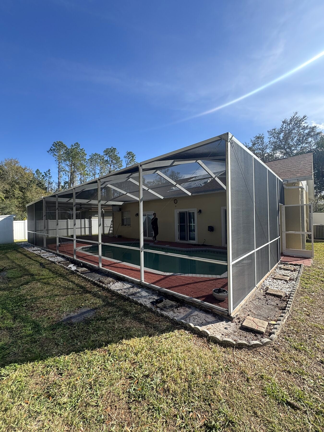 Freshly rescreened pool cage roof over a lanai